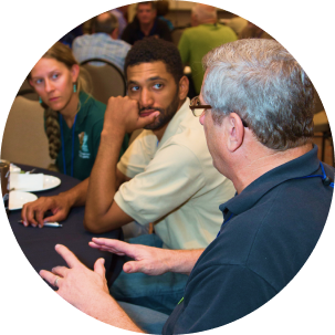 People discussing outdoor lighting issues at a meeting.